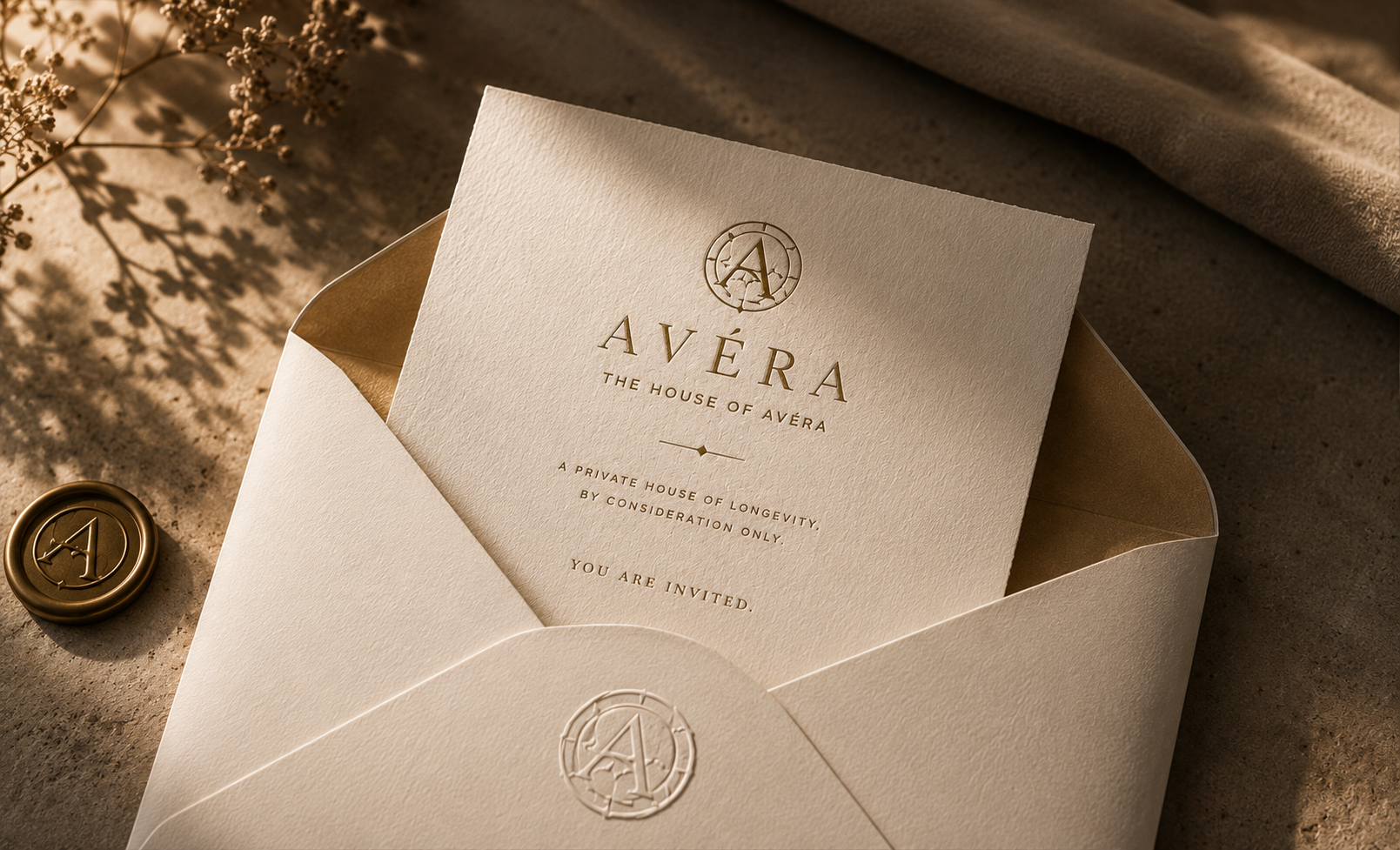 A private AVÉRA invitation resting on warm stone